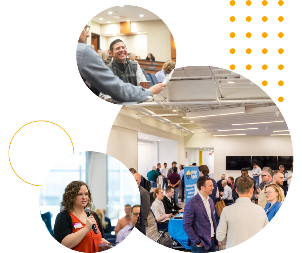 A professional networking event with diverse attendees in a spacious hall. People engage in conversation; one holds a microphone, conveying a collaborative atmosphere.